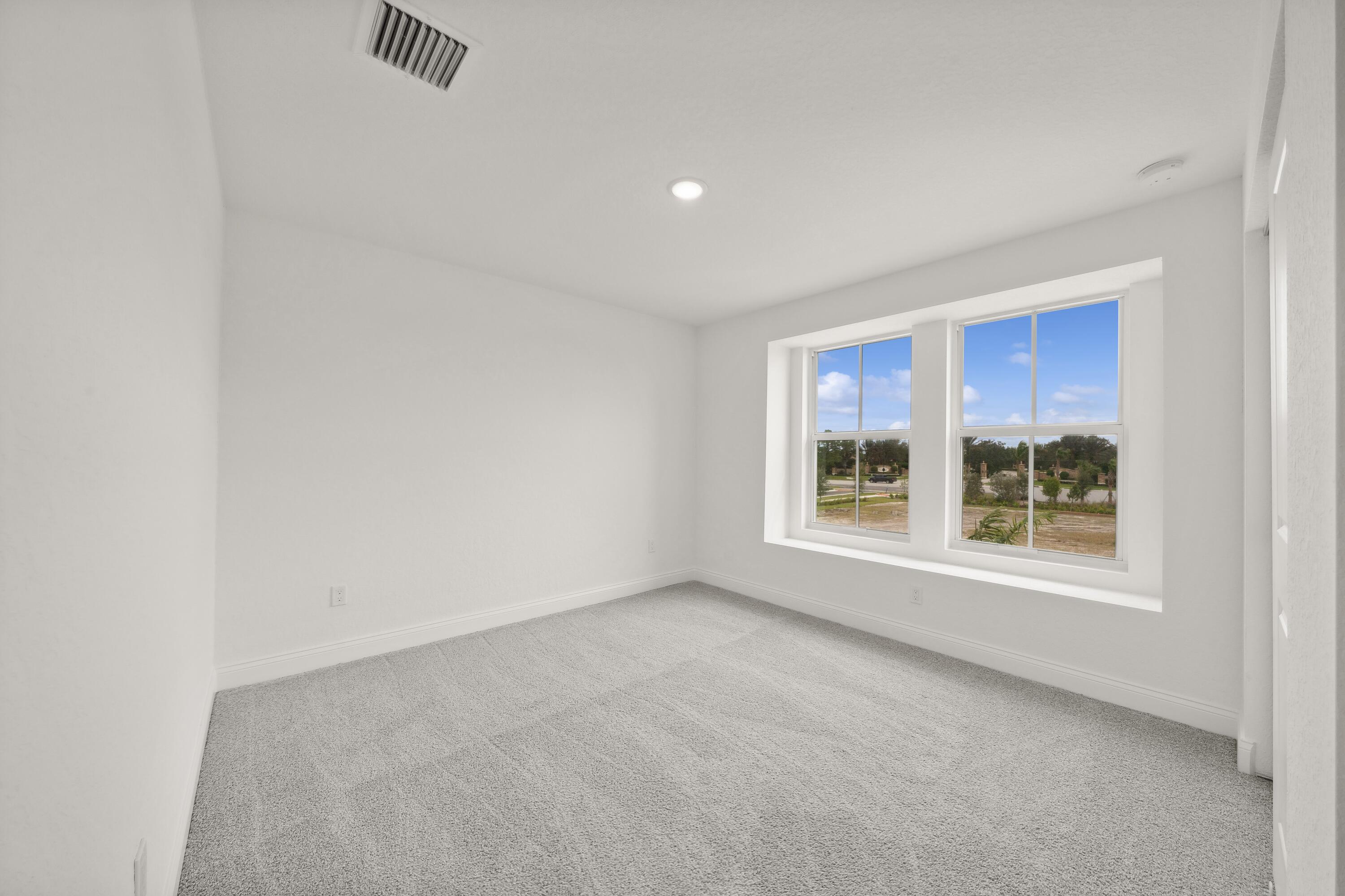 171 Southeast Birch Terrace, Unit 740 Stuart, FL 34997 - Photo 17 of 30 an empty room with windows