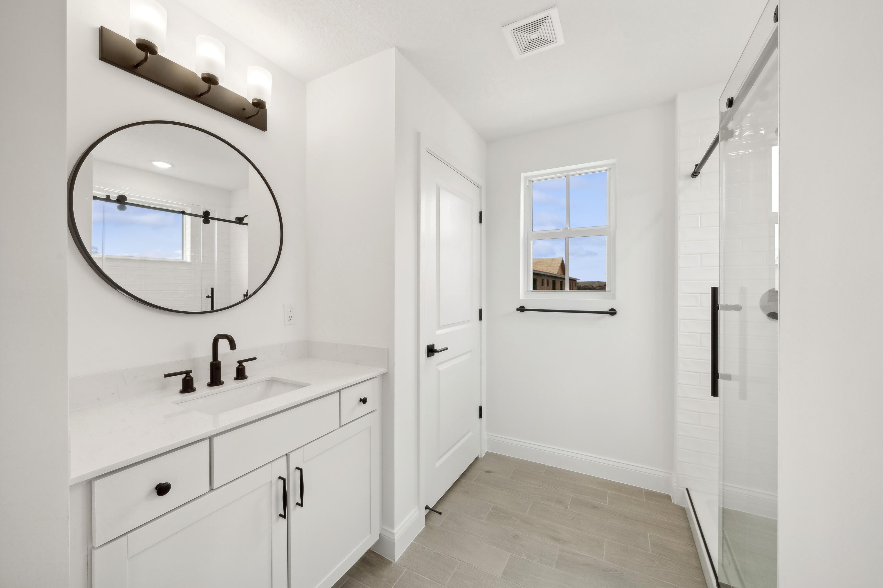 171 Southeast Birch Terrace, Unit 740 Stuart, FL 34997 - Photo 26 of 30 a bathroom with a sink and a mirror