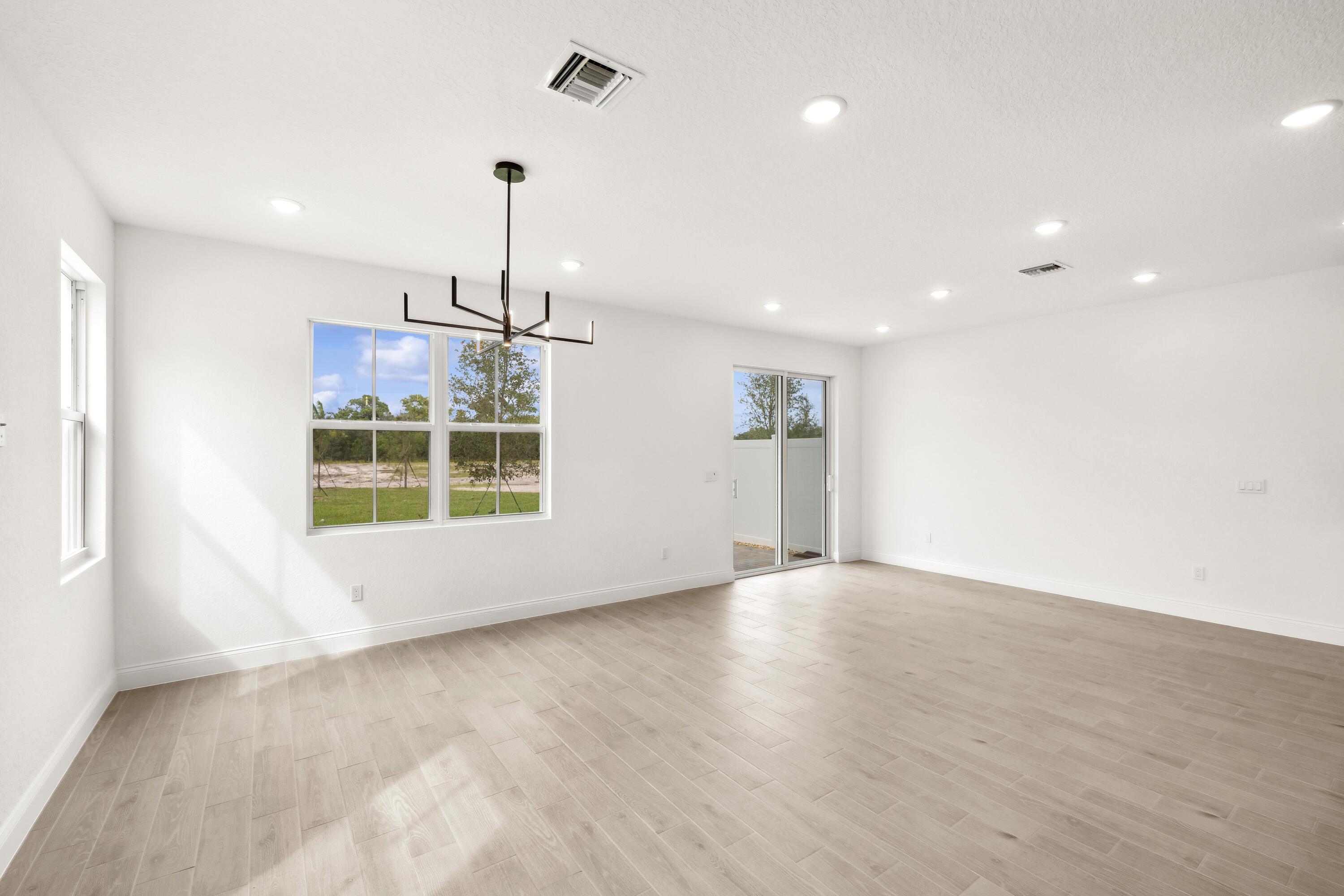 171 Southeast Birch Terrace, Unit 740 Stuart, FL 34997 - Photo 10 of 30 wooden floor in an empty room with a window