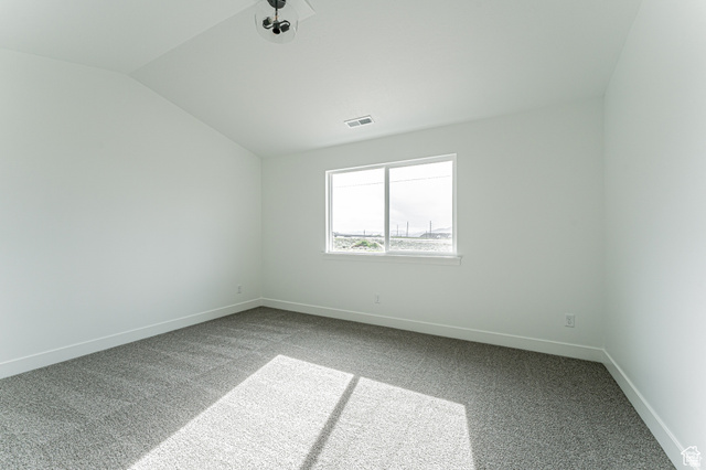 4774 Alder Drive Mapleton, UT 84664 - Photo 12 of 27 Spare room featuring light colored carpet and lofted ceiling