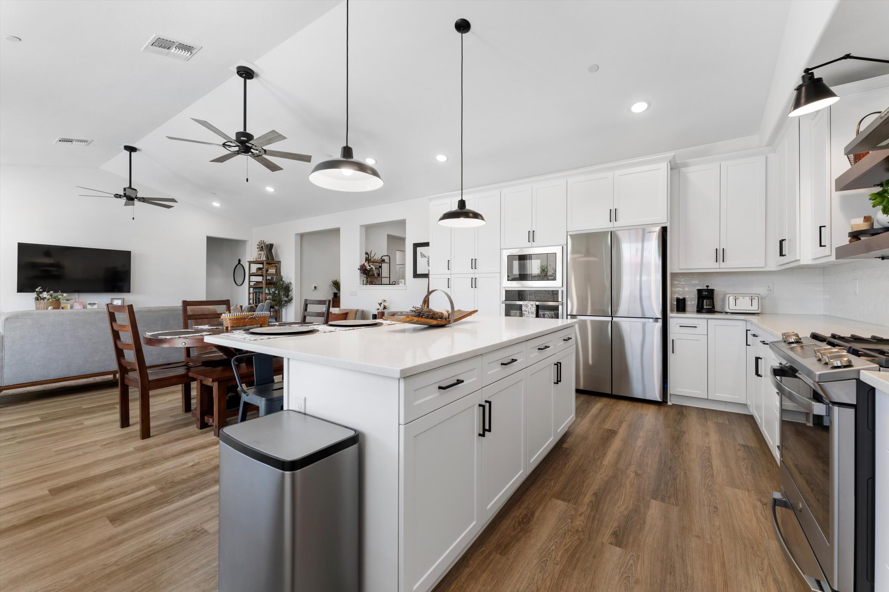1344 Bodega Drive Tehachapi, CA 93561 - Photo 15 of 34 a kitchen with white cabinets and stainless steel appliances