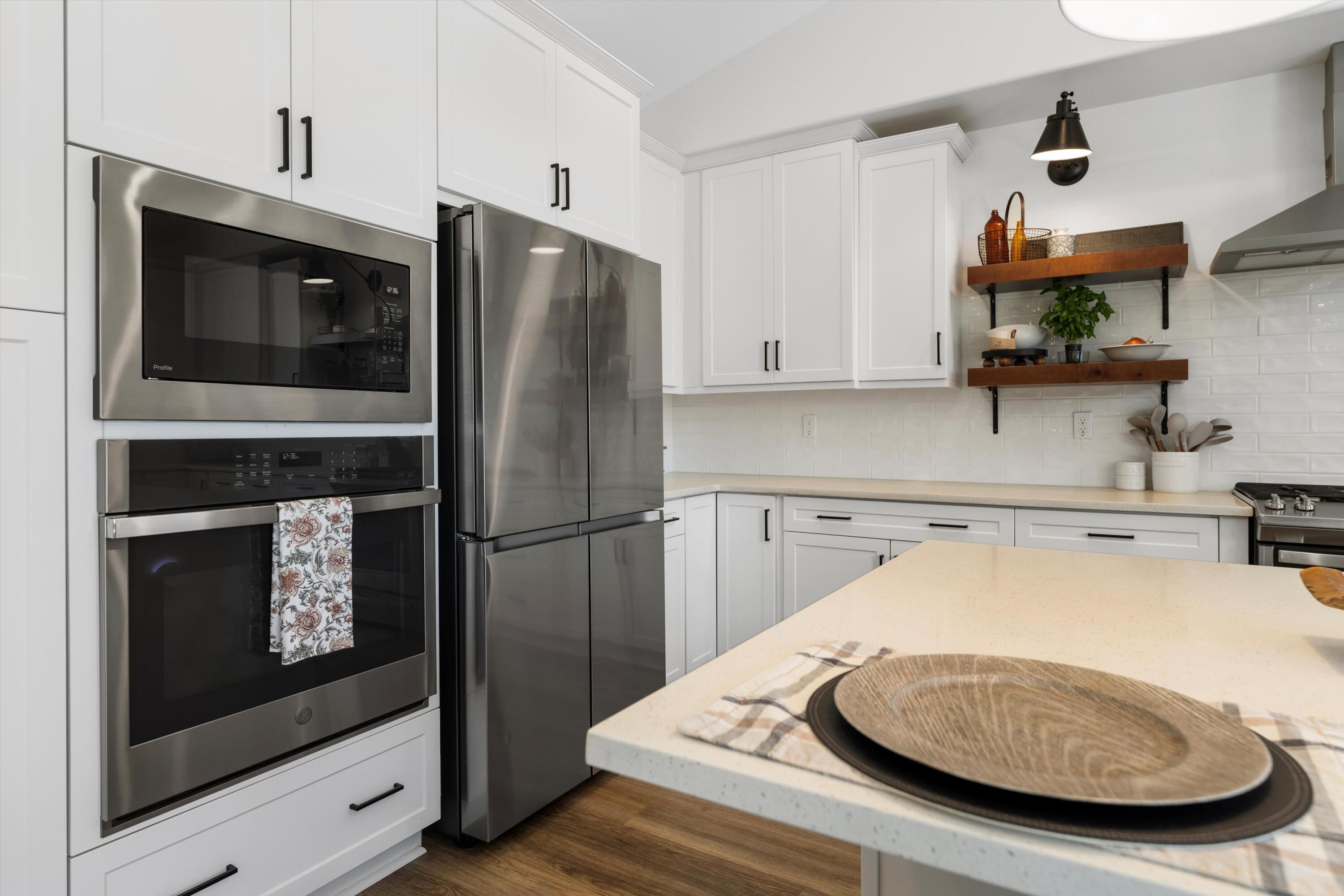 1344 Bodega Drive Tehachapi, CA 93561 - Photo 18 of 34 a kitchen with stainless steel appliances granite countertop a refrigerator a stove and a sink