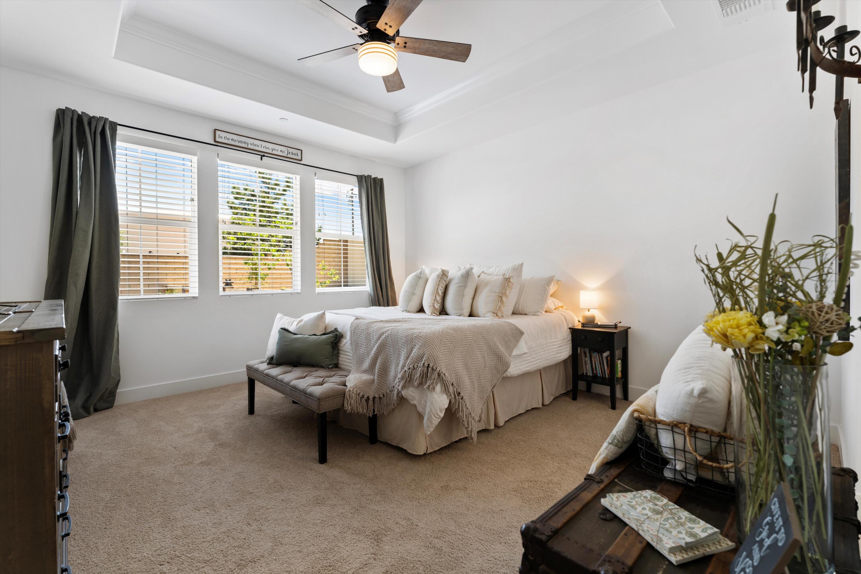 1344 Bodega Drive Tehachapi, CA 93561 - Photo 20 of 34 a spacious bedroom with a bed and a chandelier