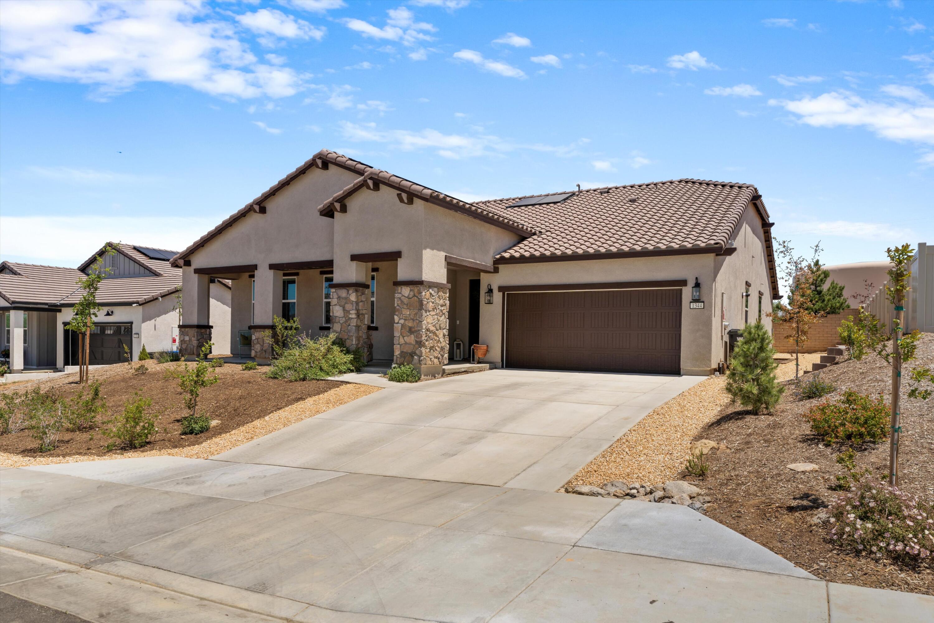 1344 Bodega Drive Tehachapi, CA 93561 - Photo 3 of 34 a front view of a house with a yard and garage