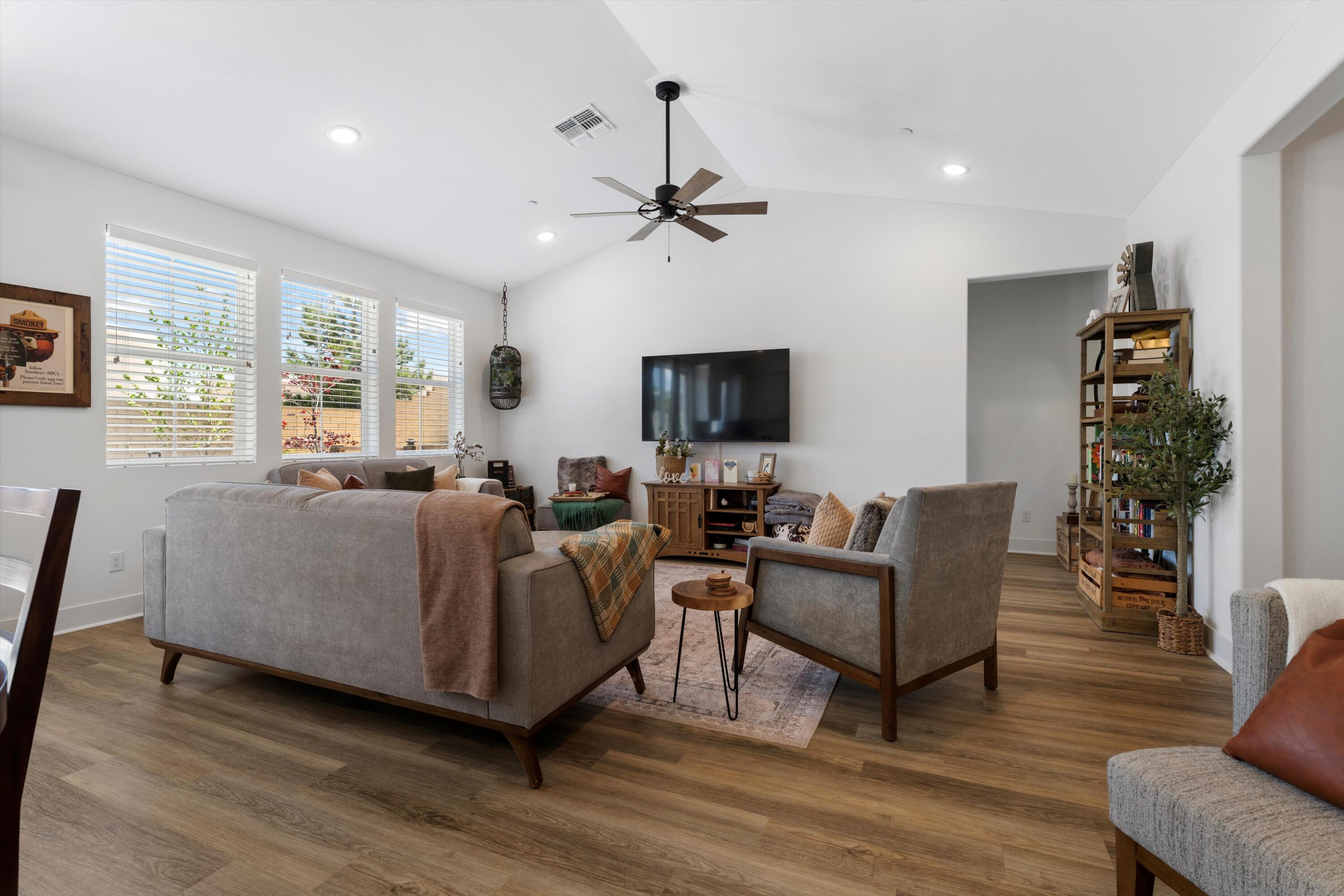 1344 Bodega Drive Tehachapi, CA 93561 - Photo 10 of 34 a living room with furniture a ceiling fan a flat screen tv and a large window
