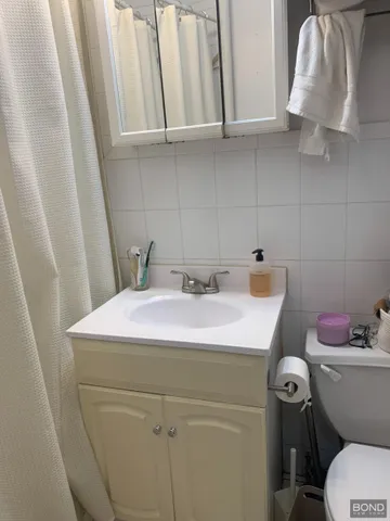 a bathroom with a sink a toilet and vanity