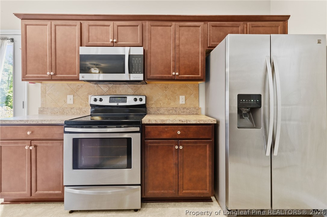 216 Meherrin Loop Raeford, NC 28376 - Photo 14 of 38 a kitchen with stainless steel appliances white cabinets and a refrigerator