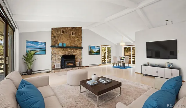 a view of an empty room with a fireplace and a window