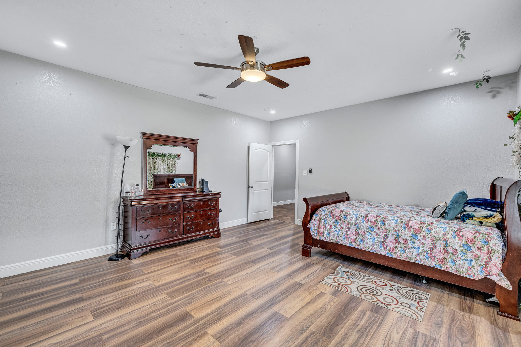 421 Las Lomas Drive Elgin, TX 78621 - Photo 15 of 30 Bedroom featuring wood finished floors, a ceiling fan, and recessed lighting