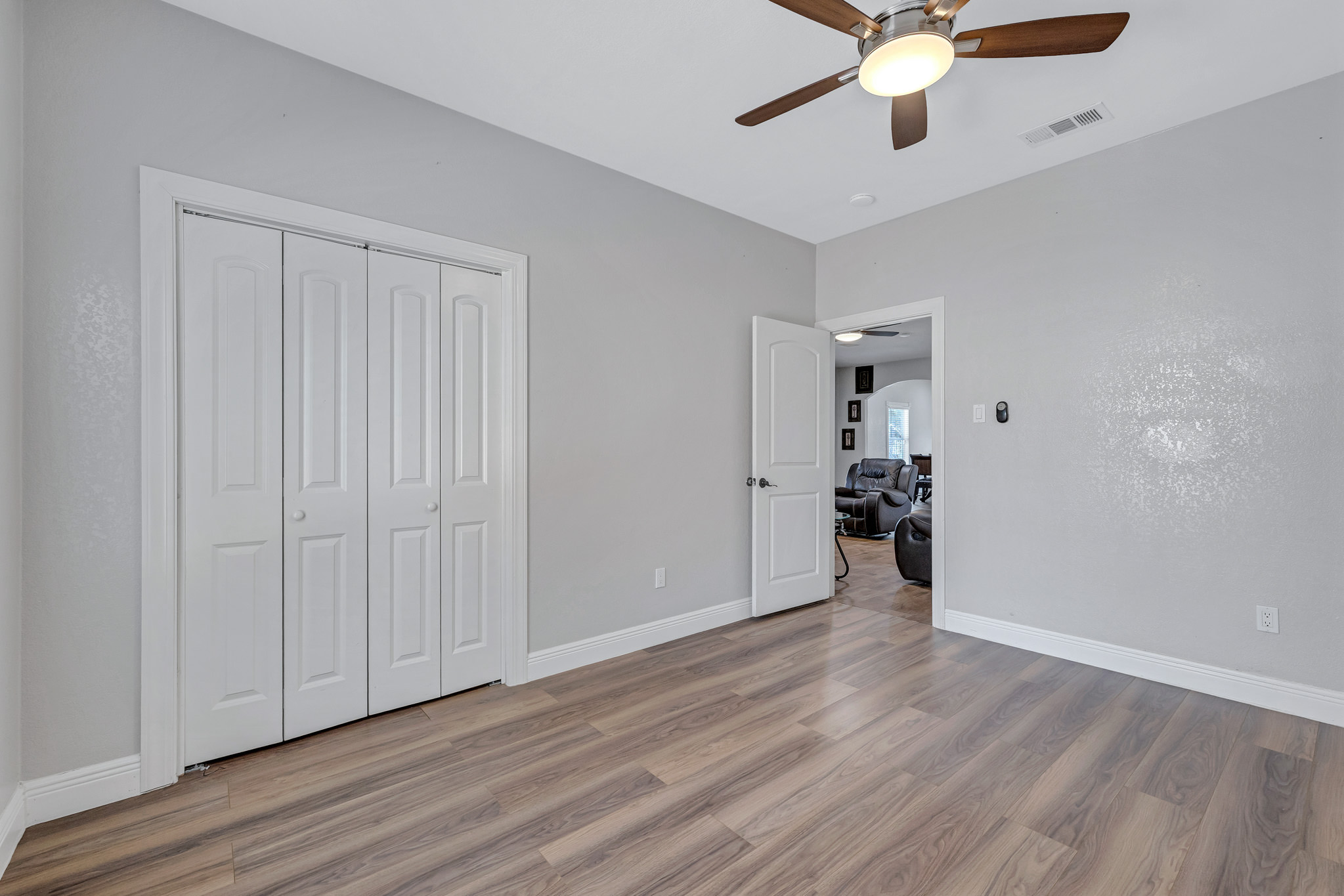 421 Las Lomas Drive Elgin, TX 78621 - Photo 19 of 30 Unfurnished bedroom with a ceiling fan, light wood finished floors, and a closet