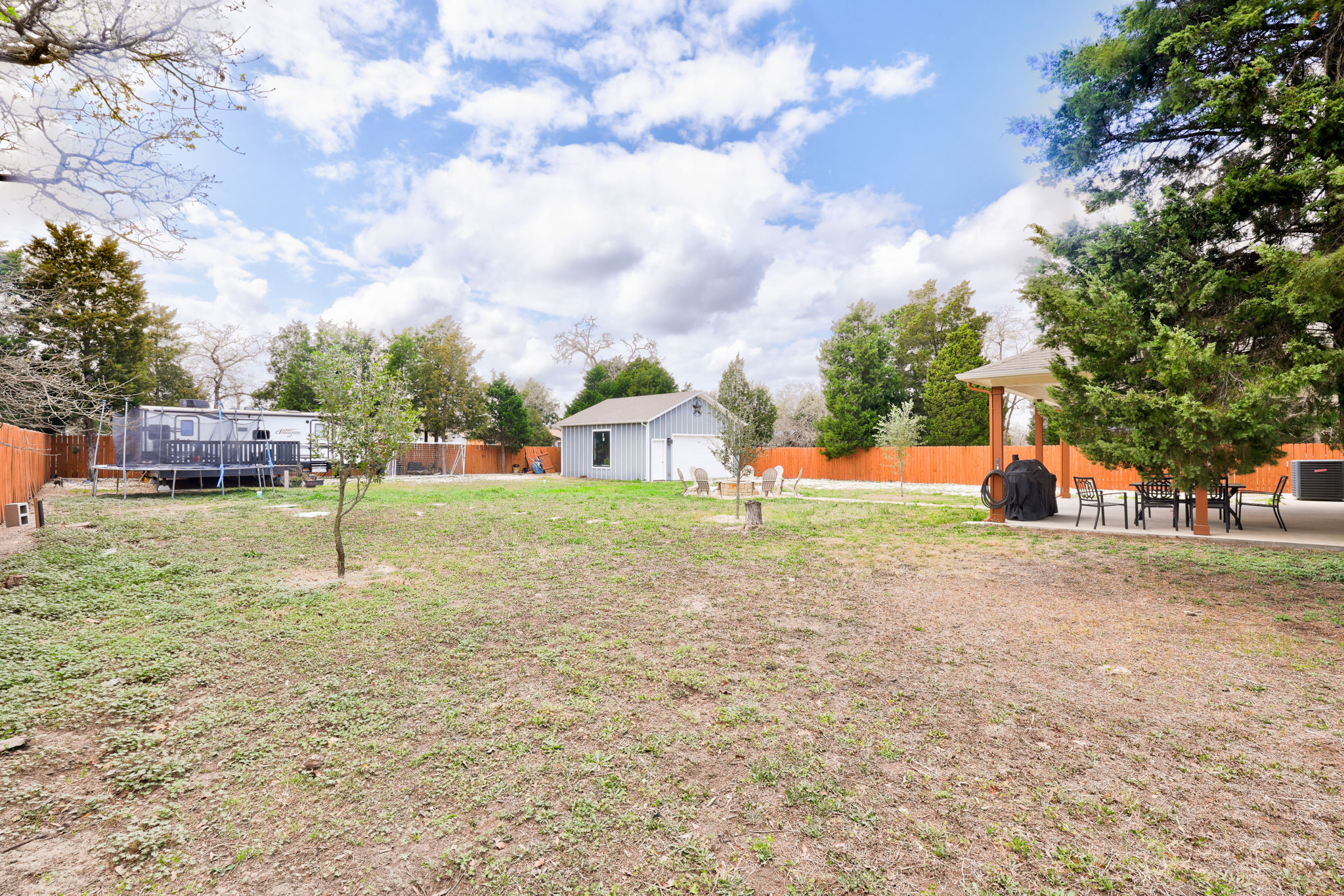 421 Las Lomas Drive Elgin, TX 78621 - Photo 25 of 30 Fenced backyard featuring an outdoor structure and a patio