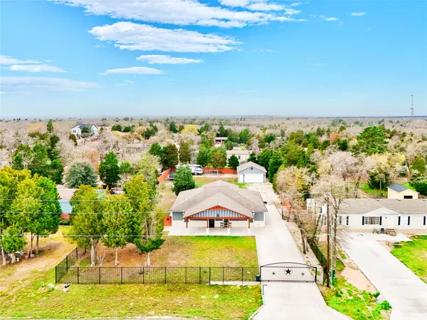 an aerial view of a residential houses with outdoor space