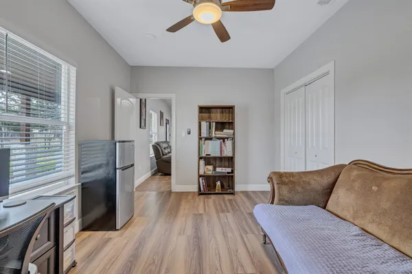 a living room with furniture and wooden floor