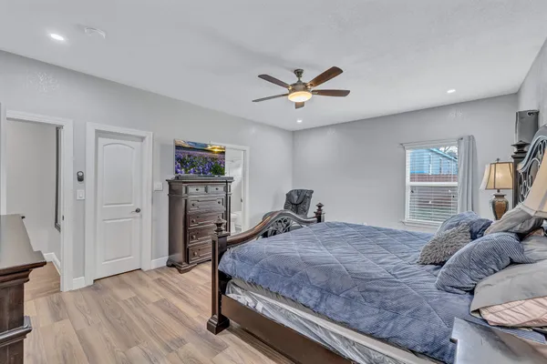 a bedroom with a bed and a chandelier