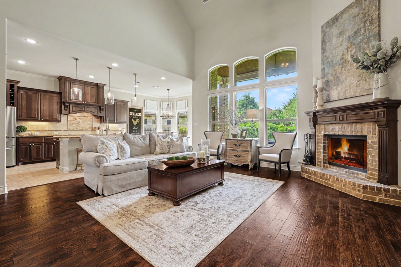 809 Prairie Dunes Drive Georgetown, TX 78628 - Photo 10 of 40 An inviting open-concept living area with a cozy brick fireplace seamlessly connects to a chef's kitchen.