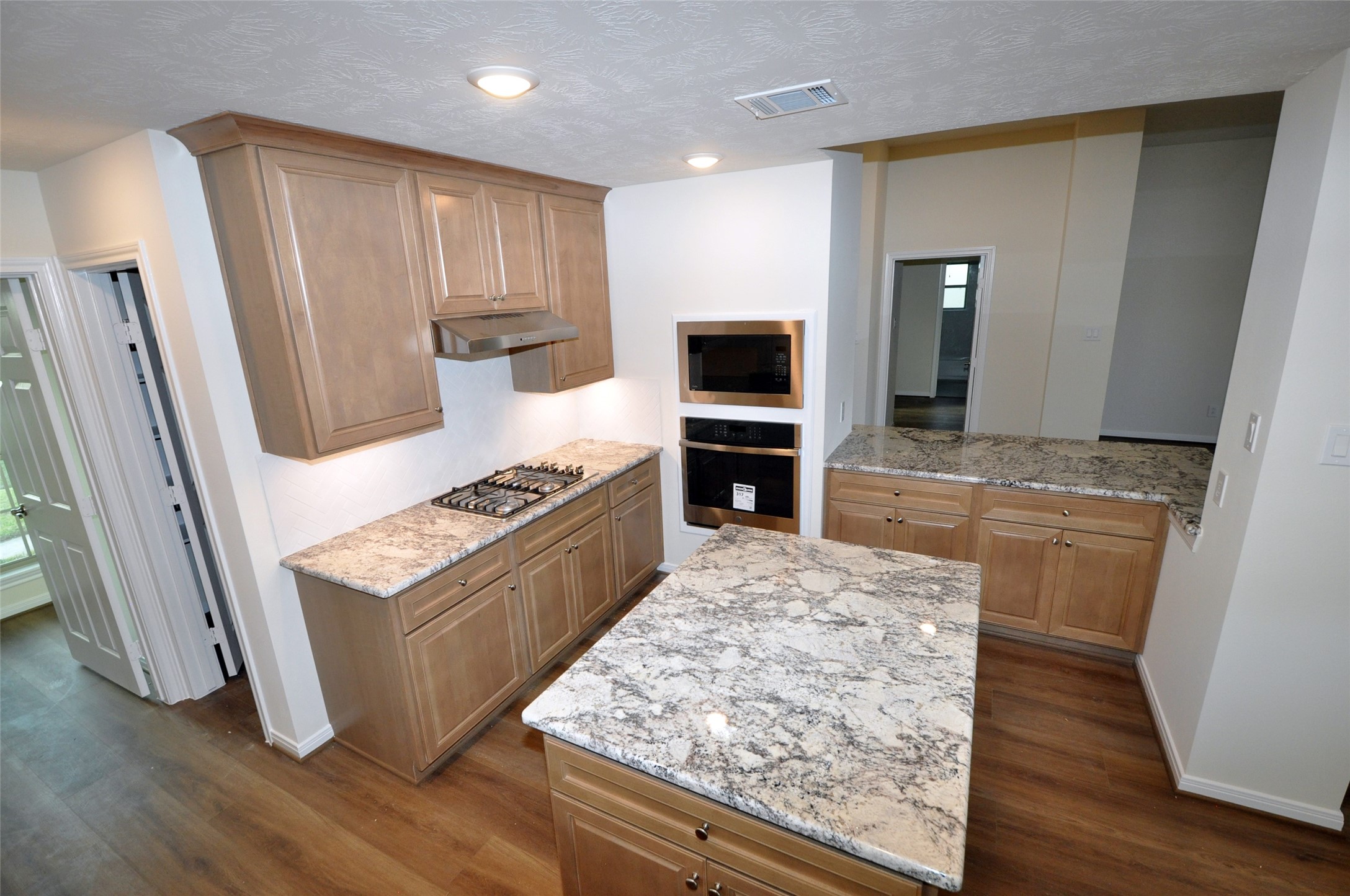 3701 Pedregal Road League City, TX 77573 - Photo 11 of 48 a kitchen with wooden floors and stainless steel appliances
