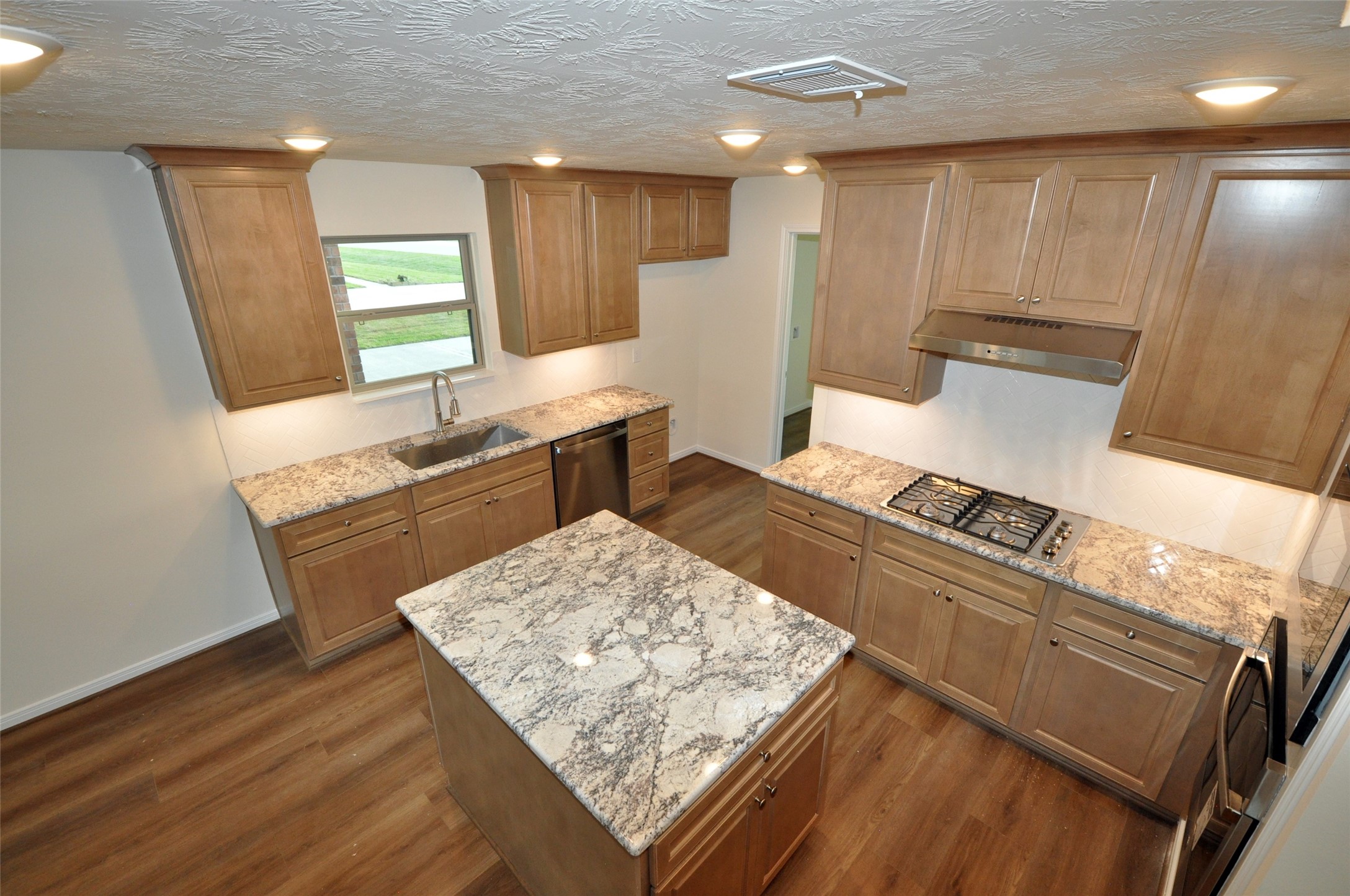 3701 Pedregal Road League City, TX 77573 - Photo 12 of 48 a kitchen with stainless steel appliances granite countertop a sink stove and wooden floor