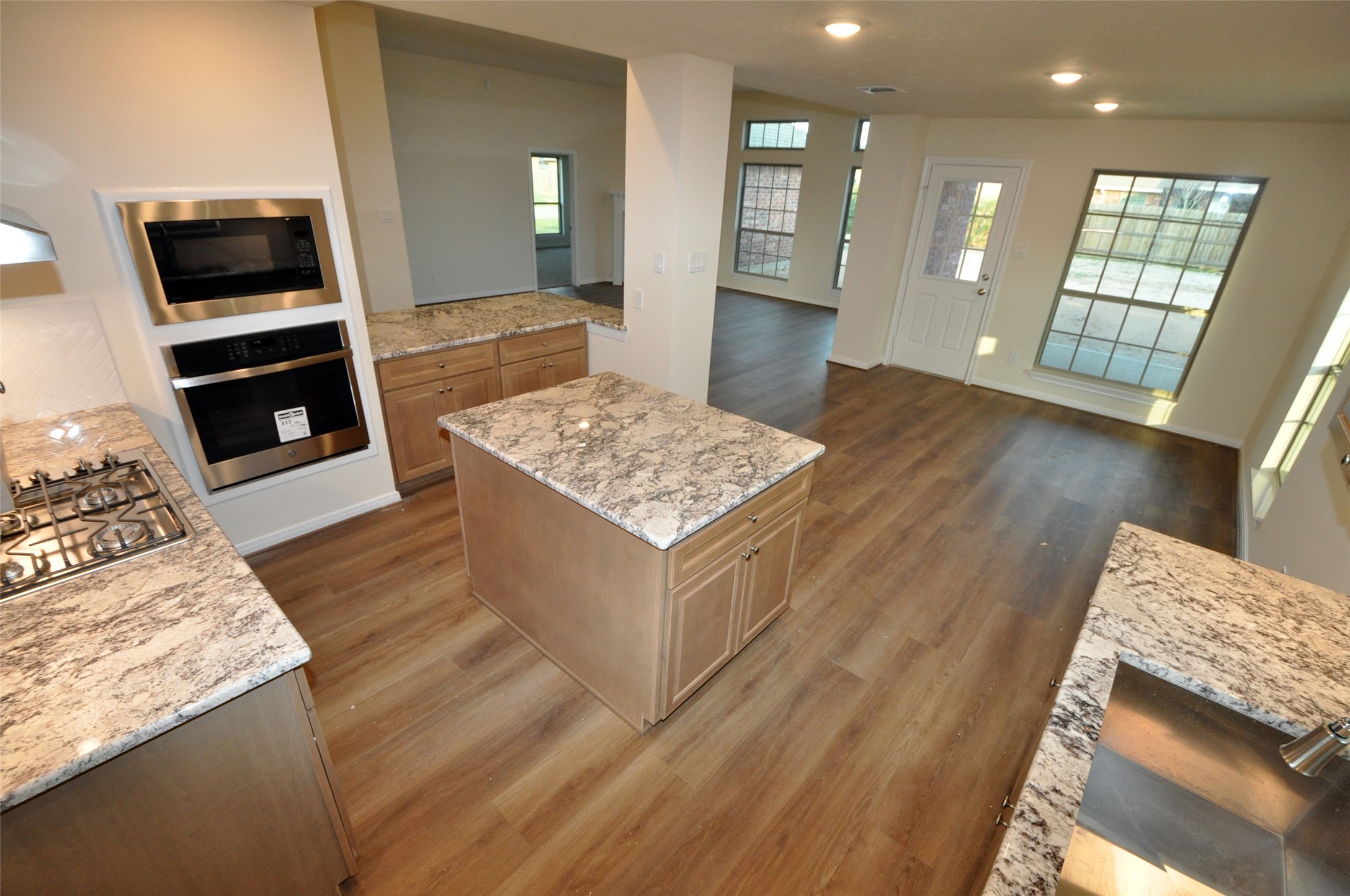 3701 Pedregal Road League City, TX 77573 - Photo 13 of 48 a living room with stainless steel appliances kitchen island granite countertop furniture and a wooden floor