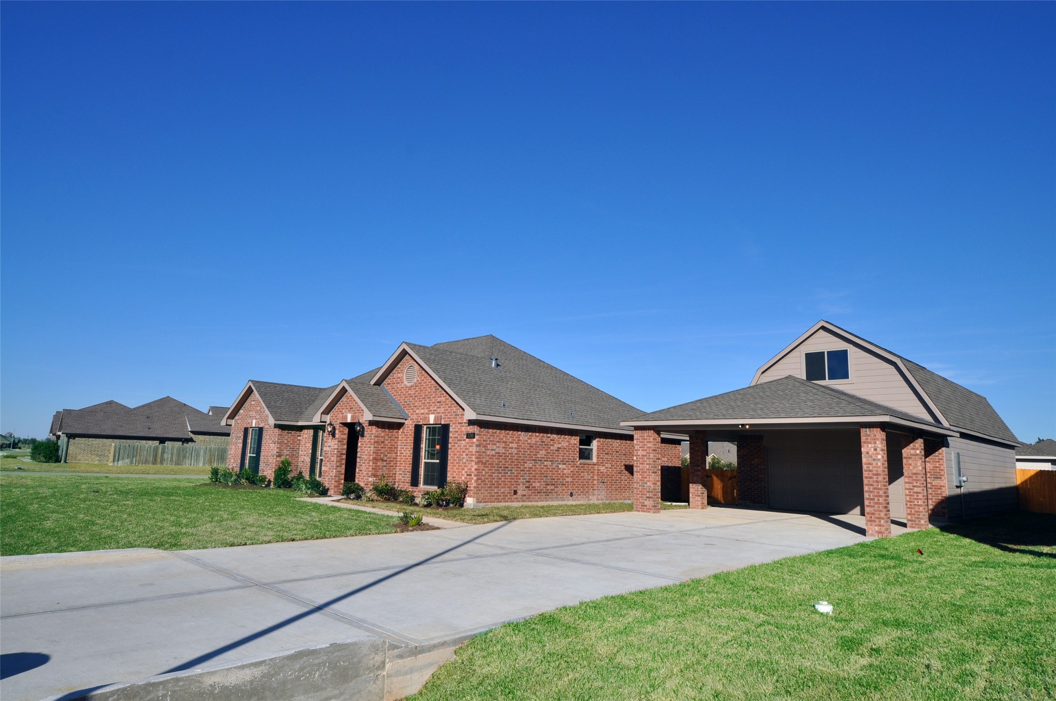 3701 Pedregal Road League City, TX 77573 - Photo 6 of 48 a front view of a house with a yard and garage