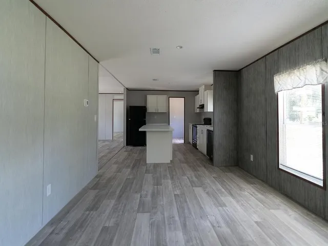 a view of a kitchen with wooden floor and a kitchen