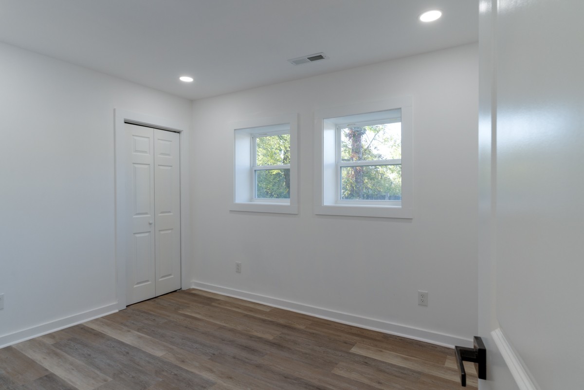 342 Crescent Drive Springfield, TN 37172 - Photo 16 of 31 an empty room with wooden floor and windows