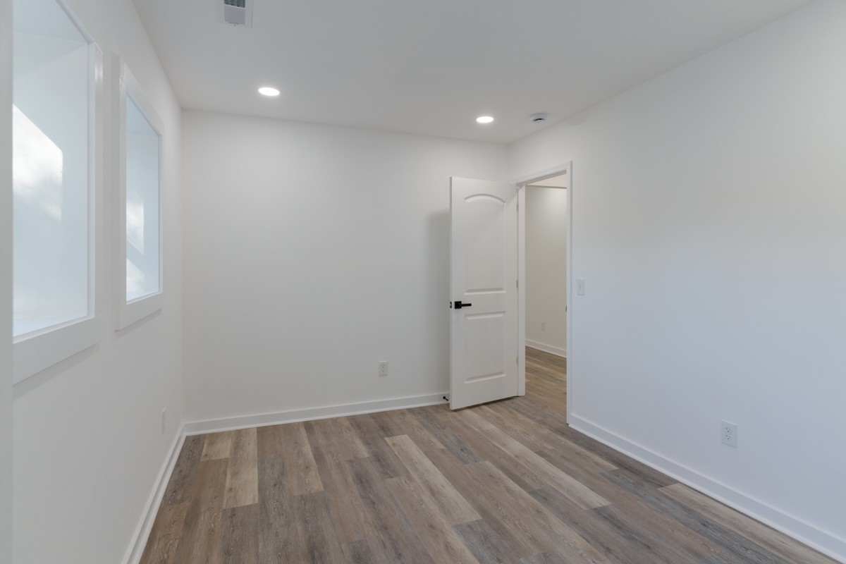 342 Crescent Drive Springfield, TN 37172 - Photo 18 of 31 a view of an empty room with wooden floor