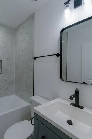 a bathroom with a sink toilet and bathtub
