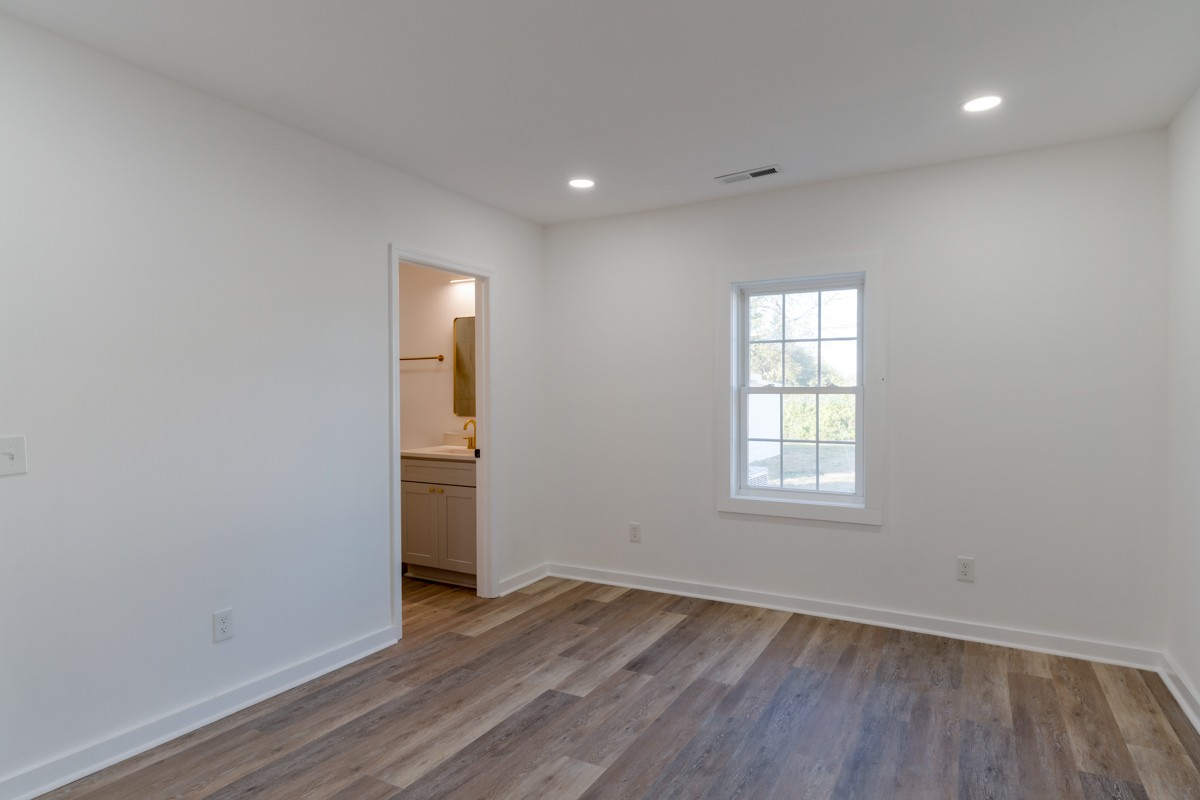 342 Crescent Drive Springfield, TN 37172 - Photo 24 of 31 an empty room with wooden floor and windows