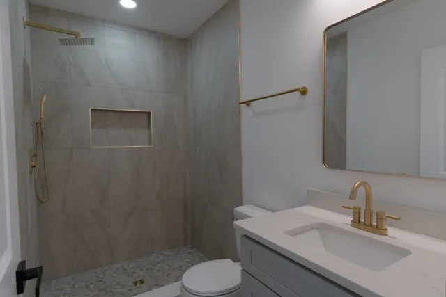 a bathroom with a sink toilet and shower