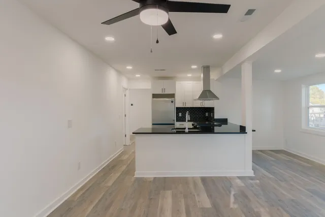 a large kitchen with a sink and a stove top oven