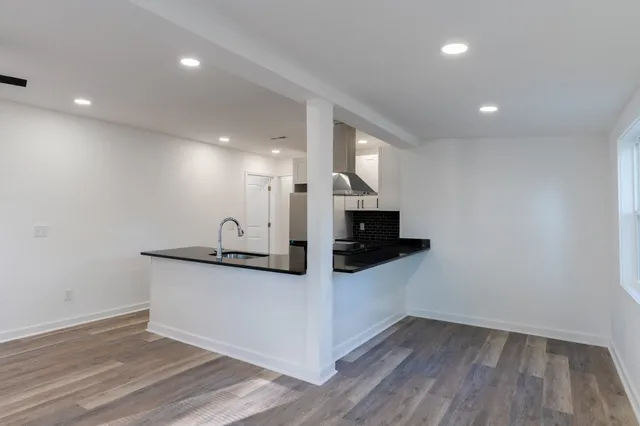 a view of a hallway with wooden floor