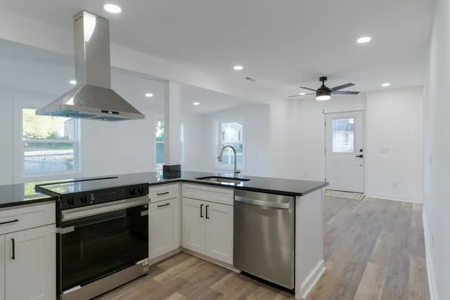 a kitchen with a sink stove and cabinets