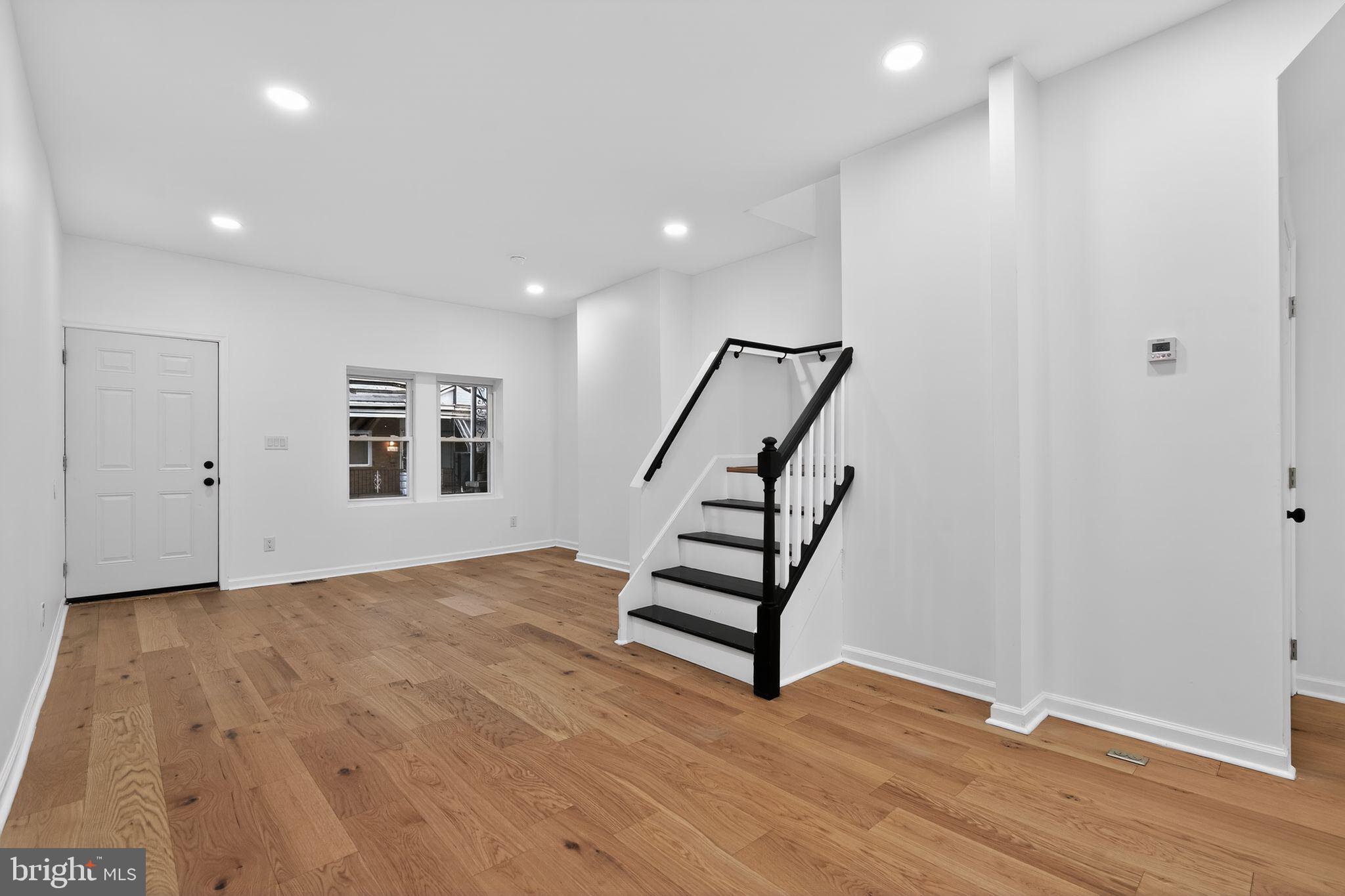 5311 Upland Street Philadelphia, PA 19143 - Photo 12 of 31 a view of an empty room with wooden floor and stairs