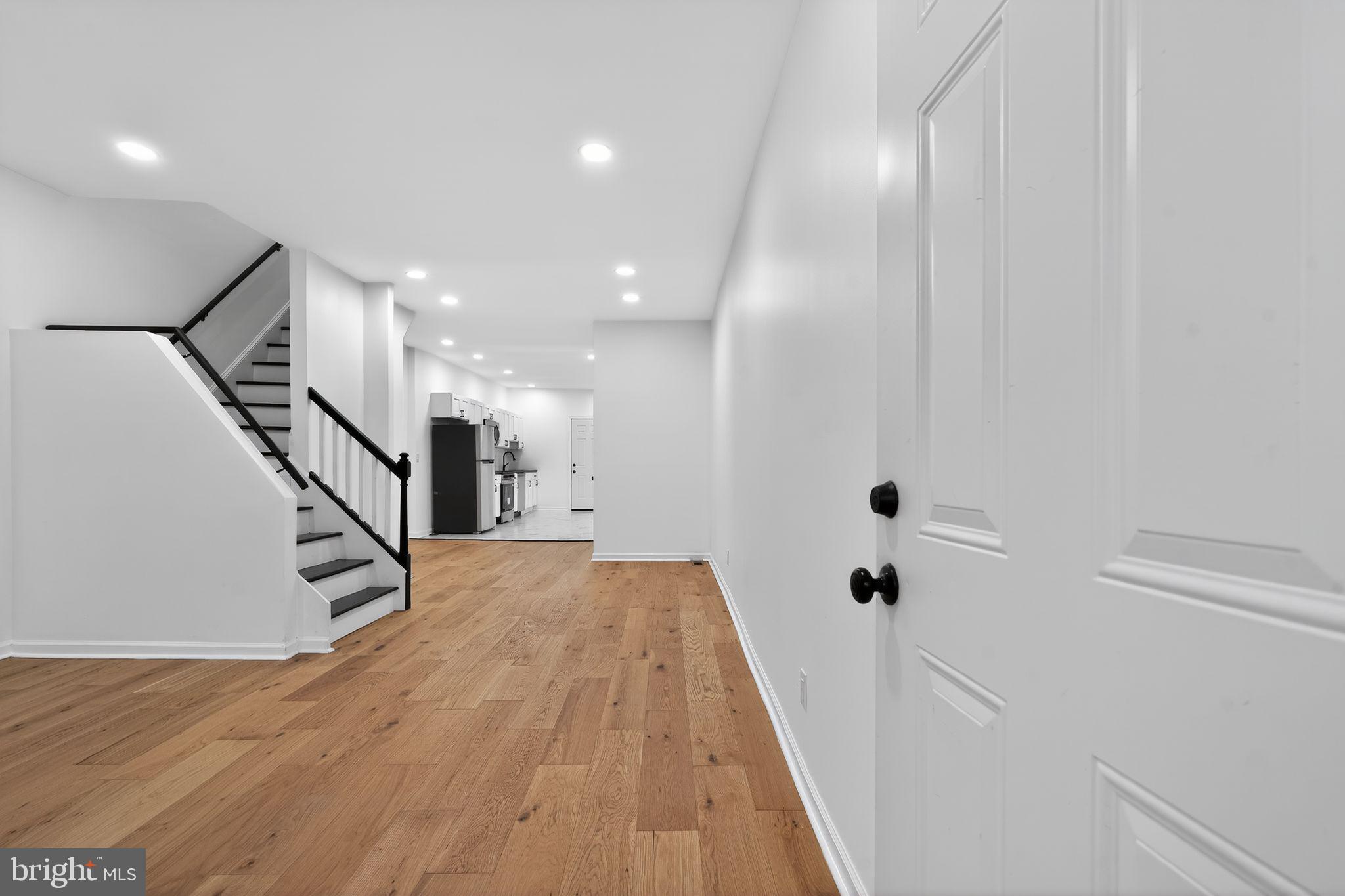 5311 Upland Street Philadelphia, PA 19143 - Photo 26 of 31 a view of a hallway with wooden floor and staircase