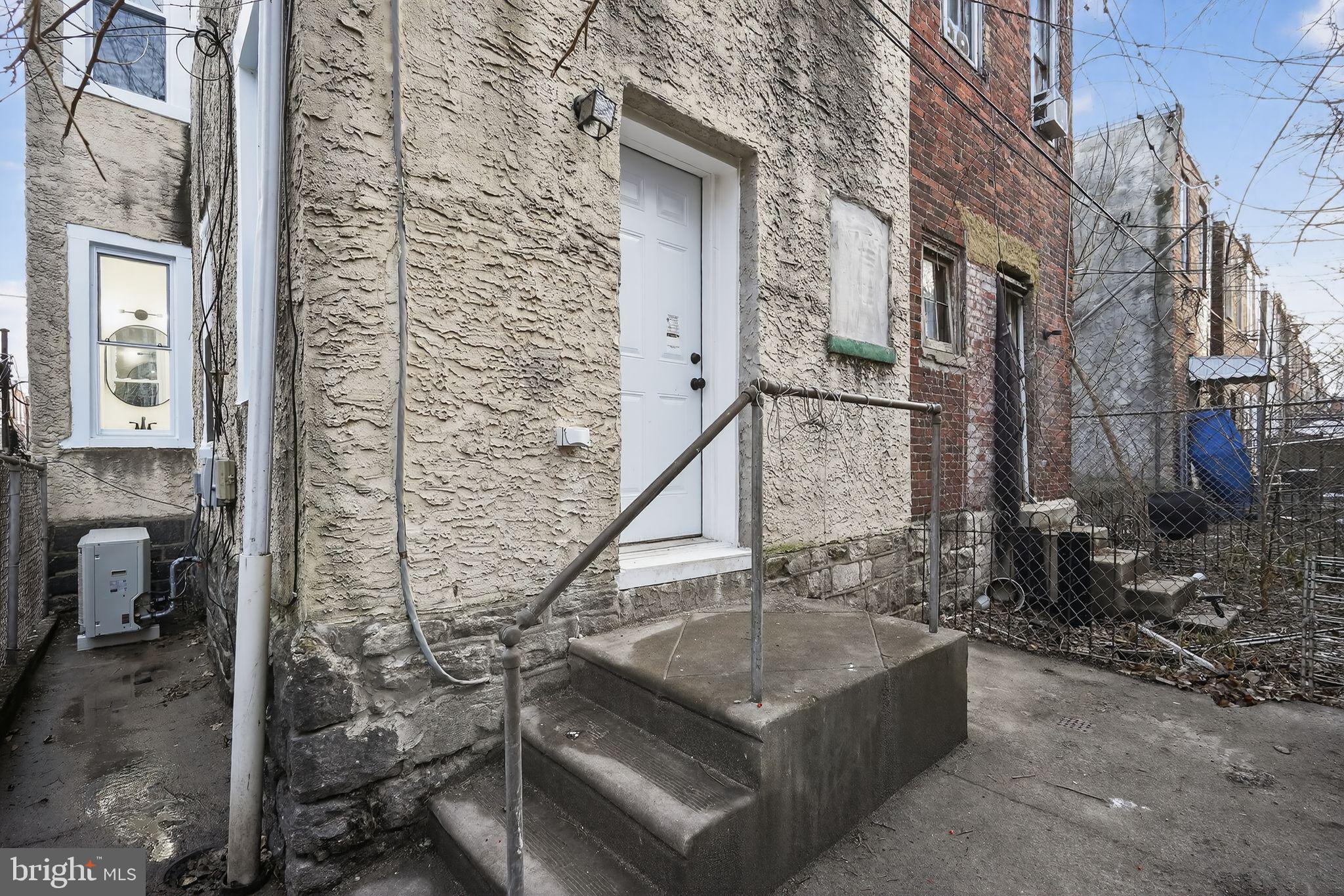 5311 Upland Street Philadelphia, PA 19143 - Photo 31 of 31 a view of a house with brick walls and a small yard