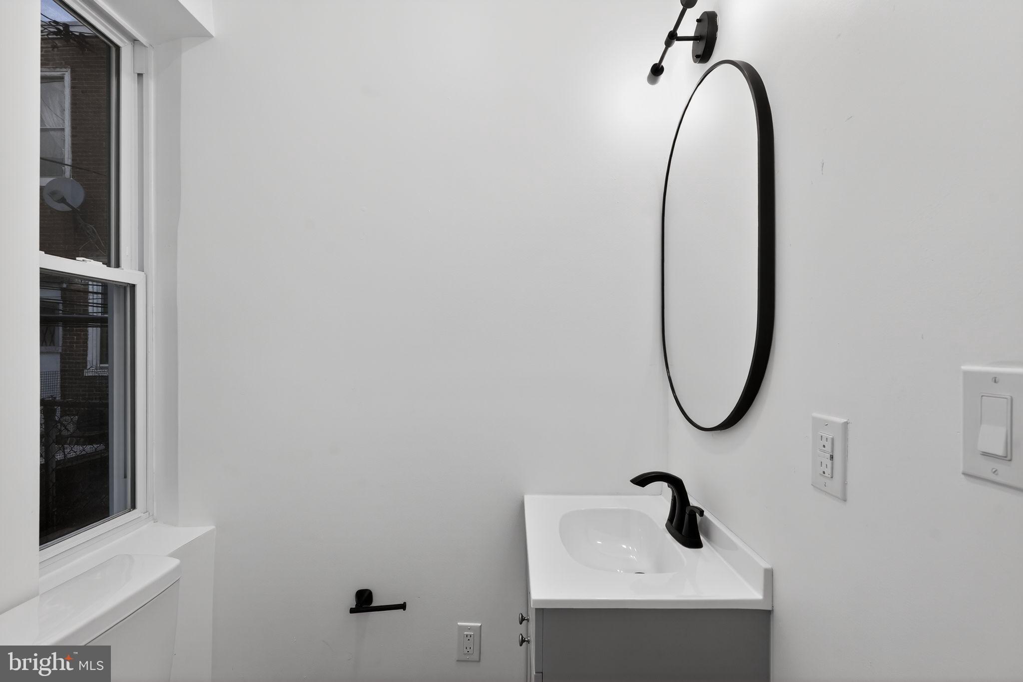 5311 Upland Street Philadelphia, PA 19143 - Photo 10 of 31 a bathroom with a sink and mirror