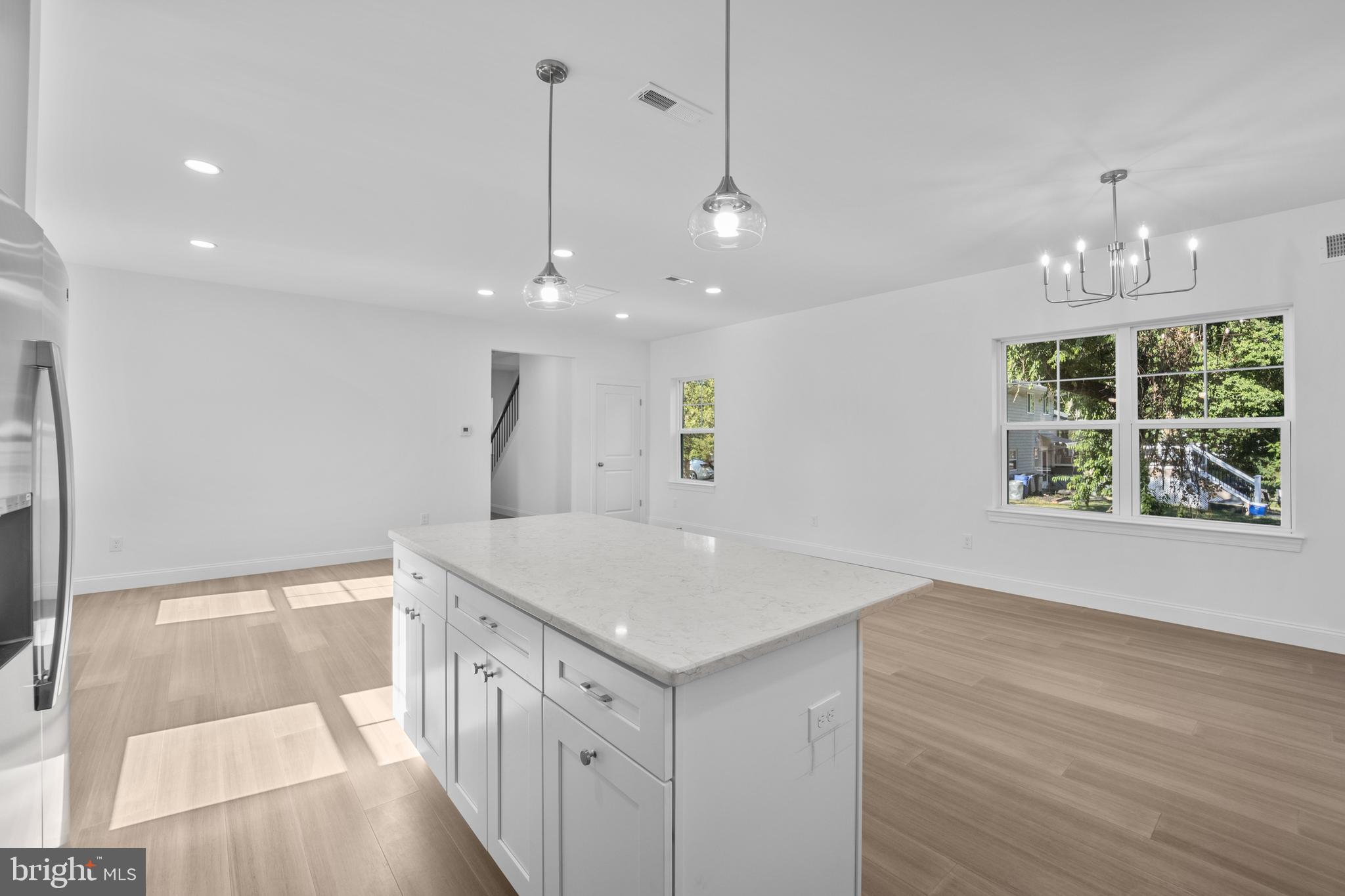 492 Ellis Avenue Lawnside, NJ 08045 - Photo 12 of 33 a kitchen with a sink chandelier and wooden floor