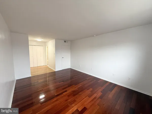 a view of an empty room and wooden floor