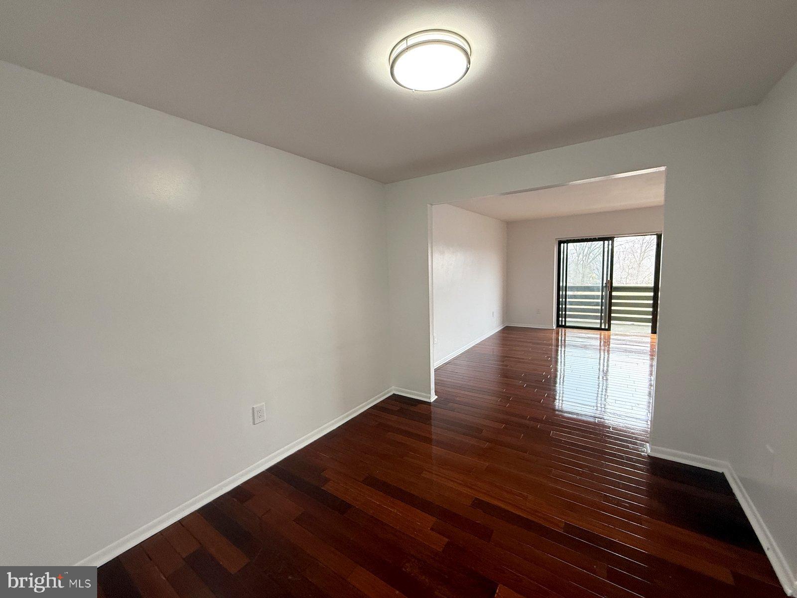 606 Cooper Landing Road, Unit B6L Cherry Hill, NJ 08002 - Photo 5 of 14 wooden floor in an empty room with a window