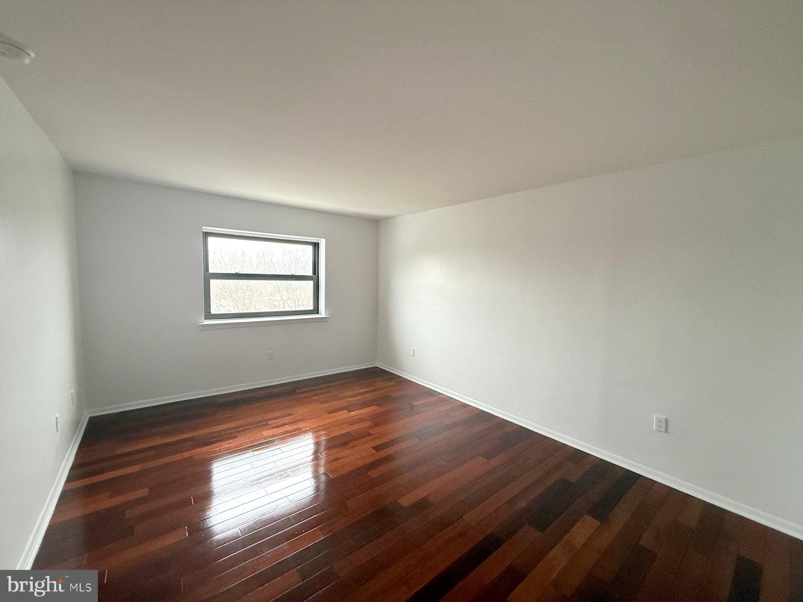 606 Cooper Landing Road, Unit B6L Cherry Hill, NJ 08002 - Photo 9 of 14 an empty room with wooden floor and windows