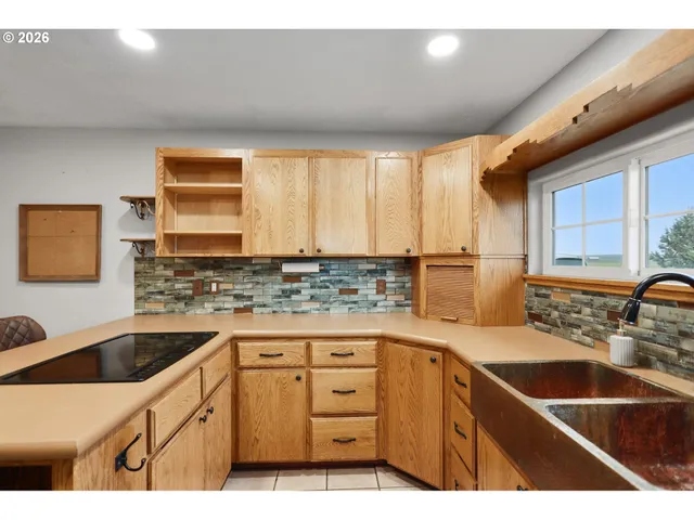 a kitchen with granite countertop a sink and cabinets