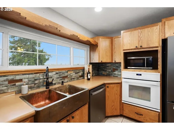 a kitchen that has a sink and a stove top oven