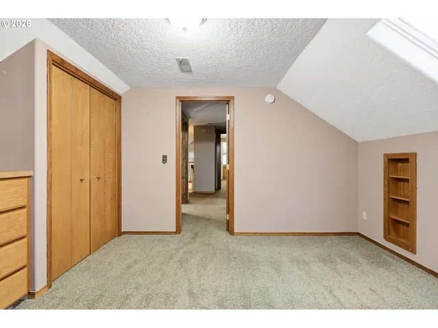 a view of walk in closet with clothes