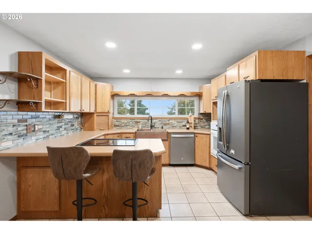 a kitchen with kitchen island a counter top space cabinets and stainless steel appliances
