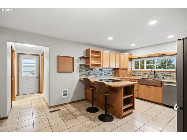 a kitchen with a stove sink and cabinets