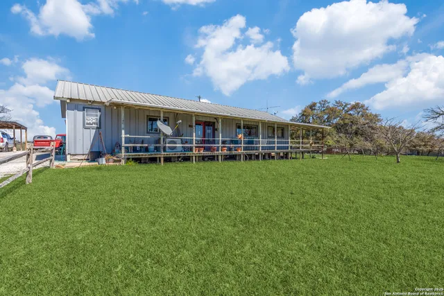 a view of a house with a backyard