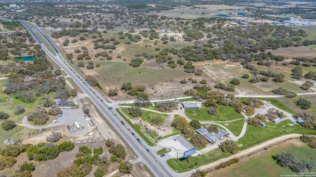 a backyard of a house with lots of green space and fountain