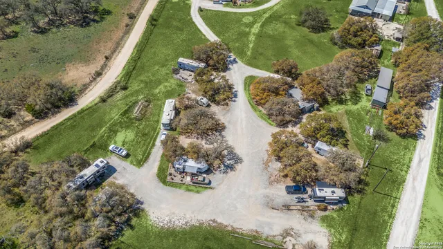 an aerial view of a house with a yard