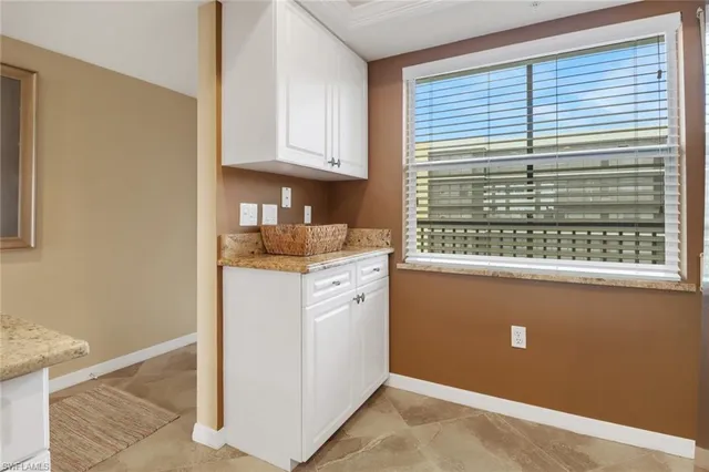 a view of kitchen cabinets and window