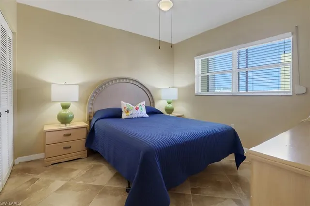 a bedroom with a bed and a potted plant